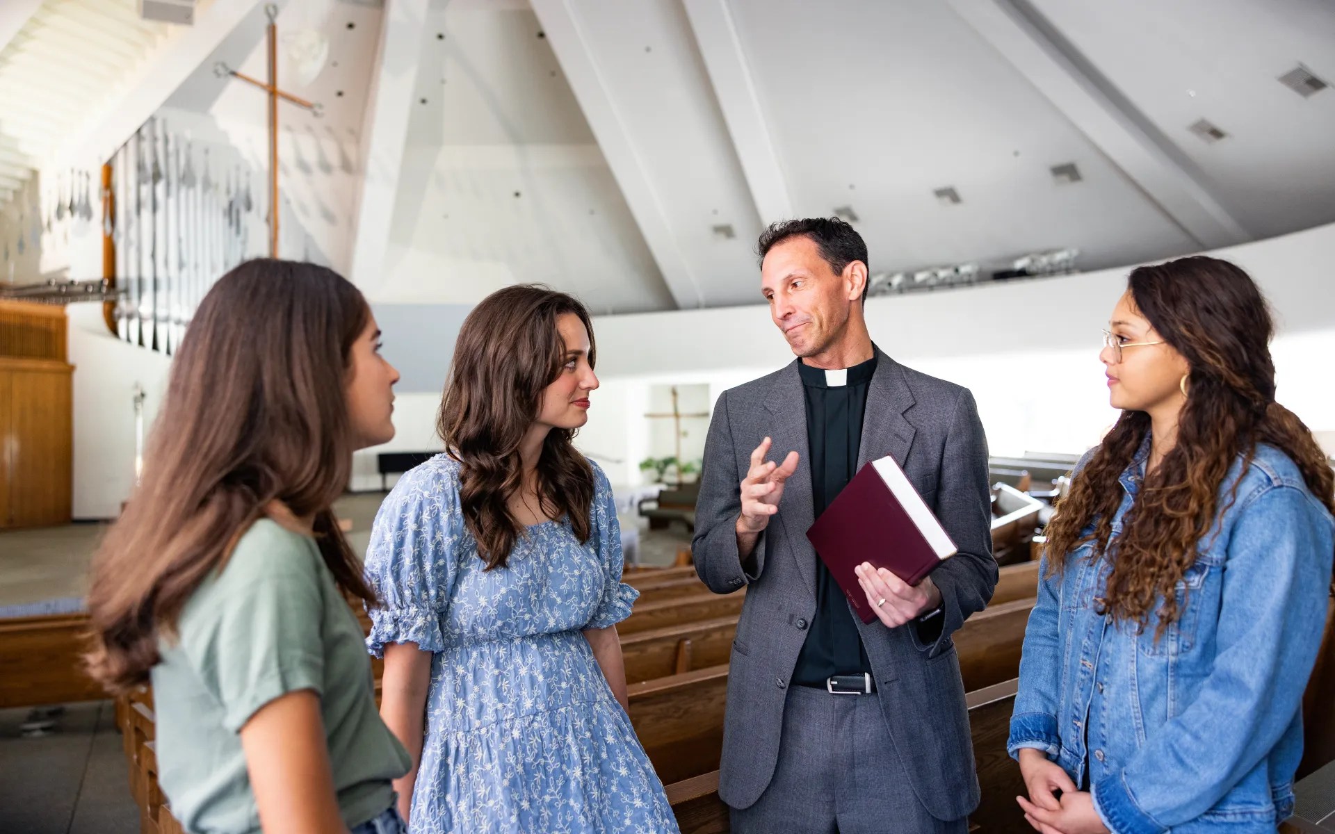 A man holding a book and a group of girls