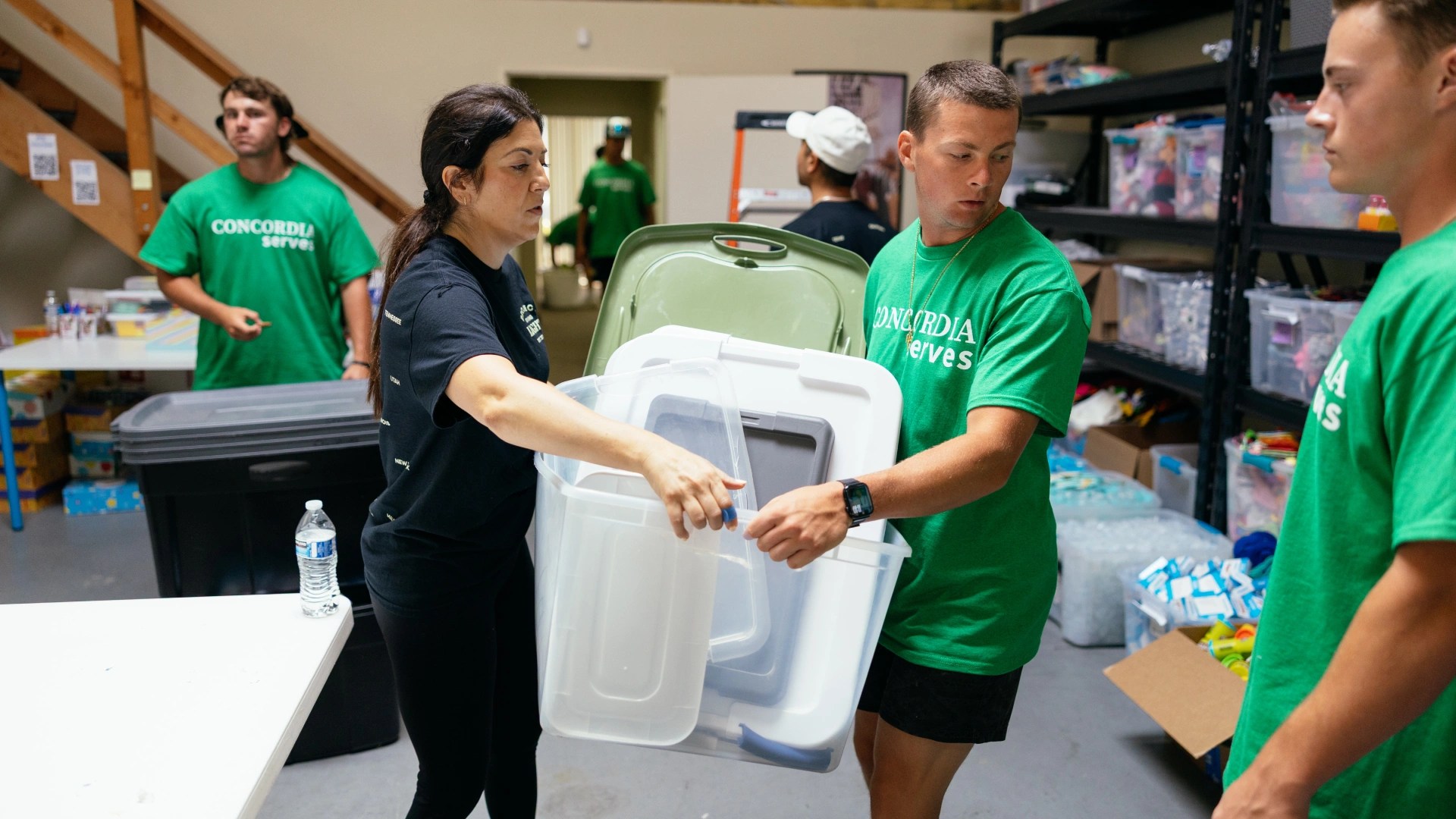 A man and woman holding plastic containers