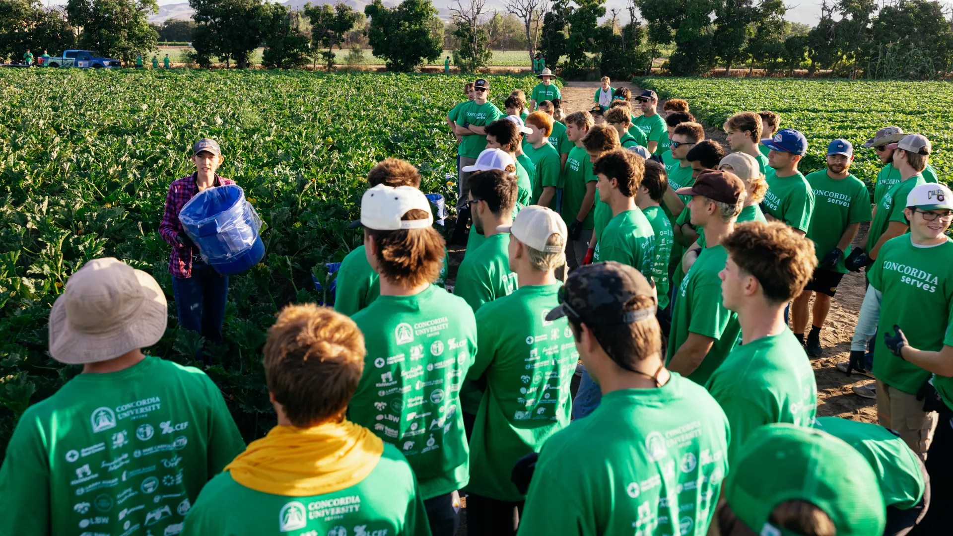 A group of people in green shirts