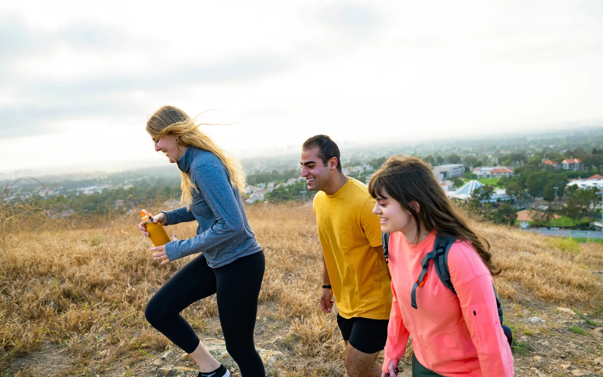 A group of people walking on a hill