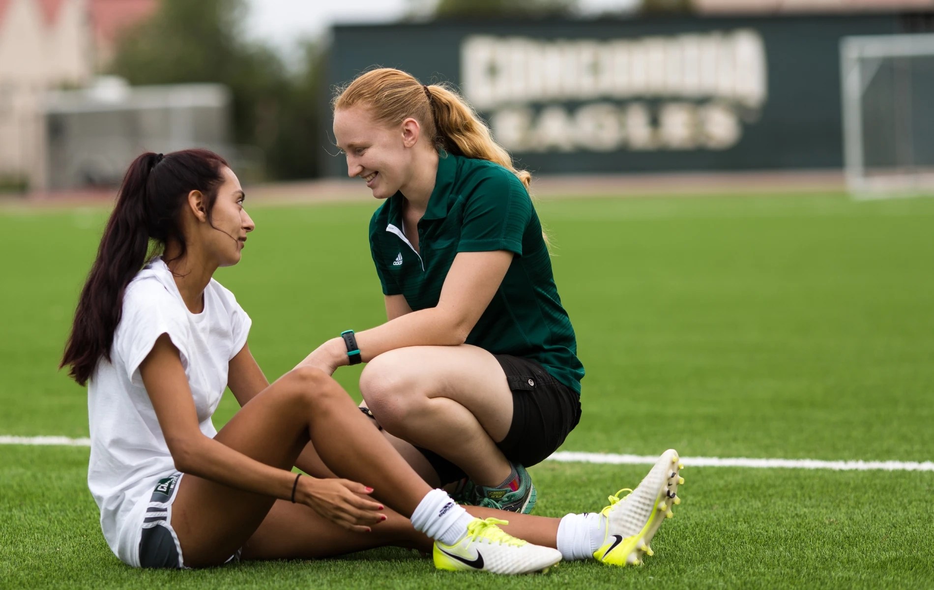 Two women sitting on the ground