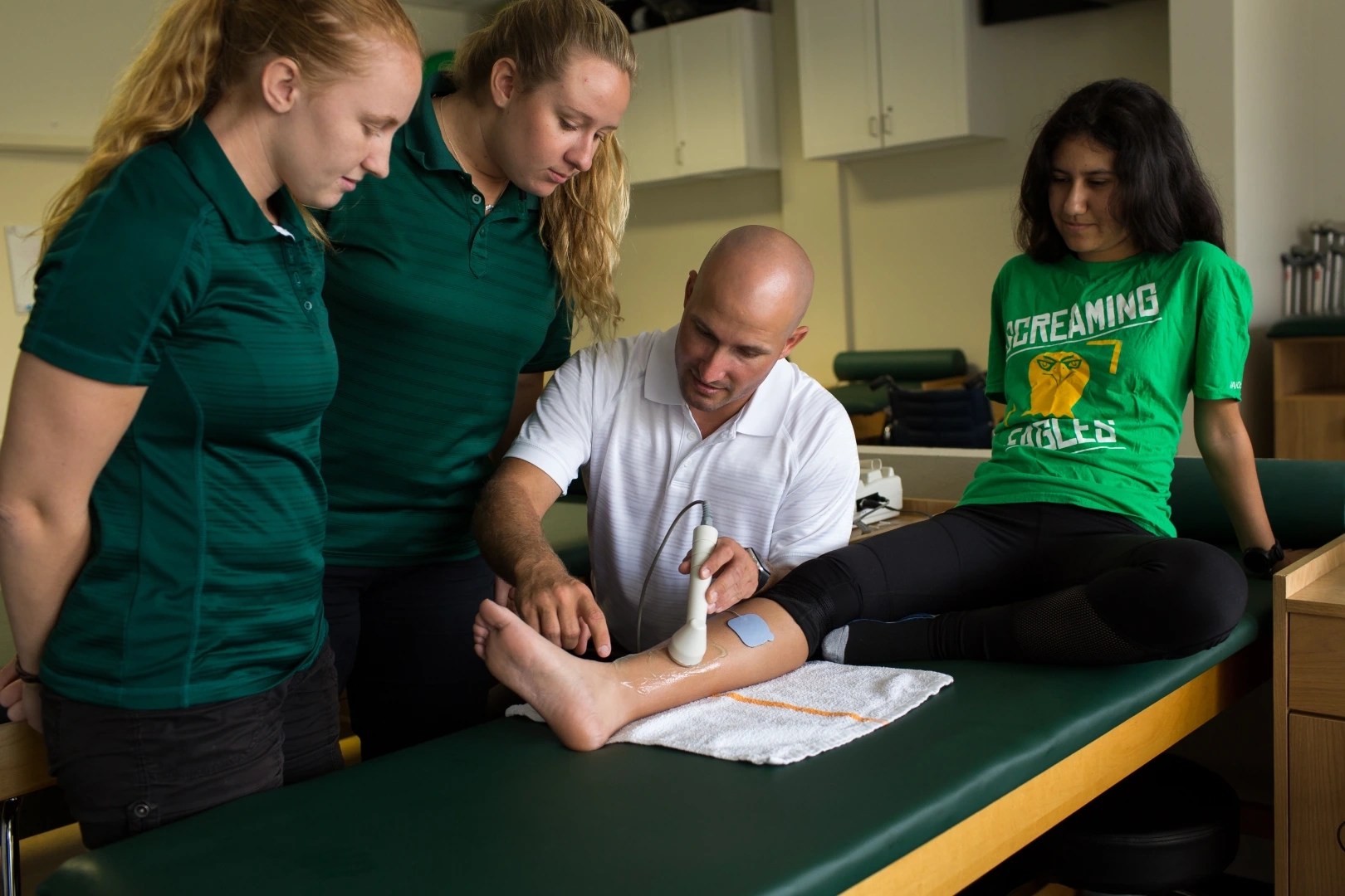 A group of people around a person's leg