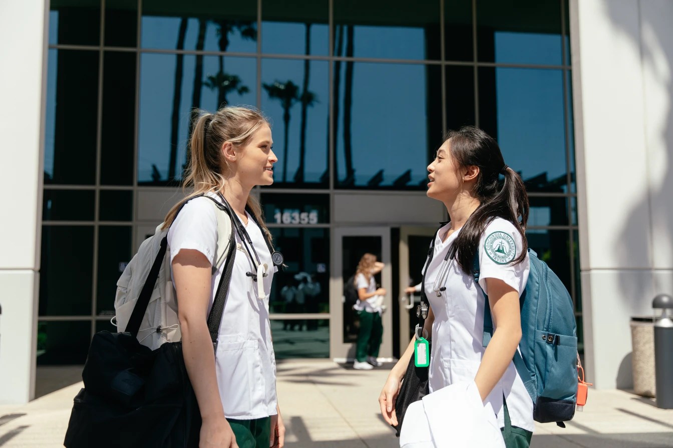 Two Concordia University Irvine nursing students talking outside the campus building