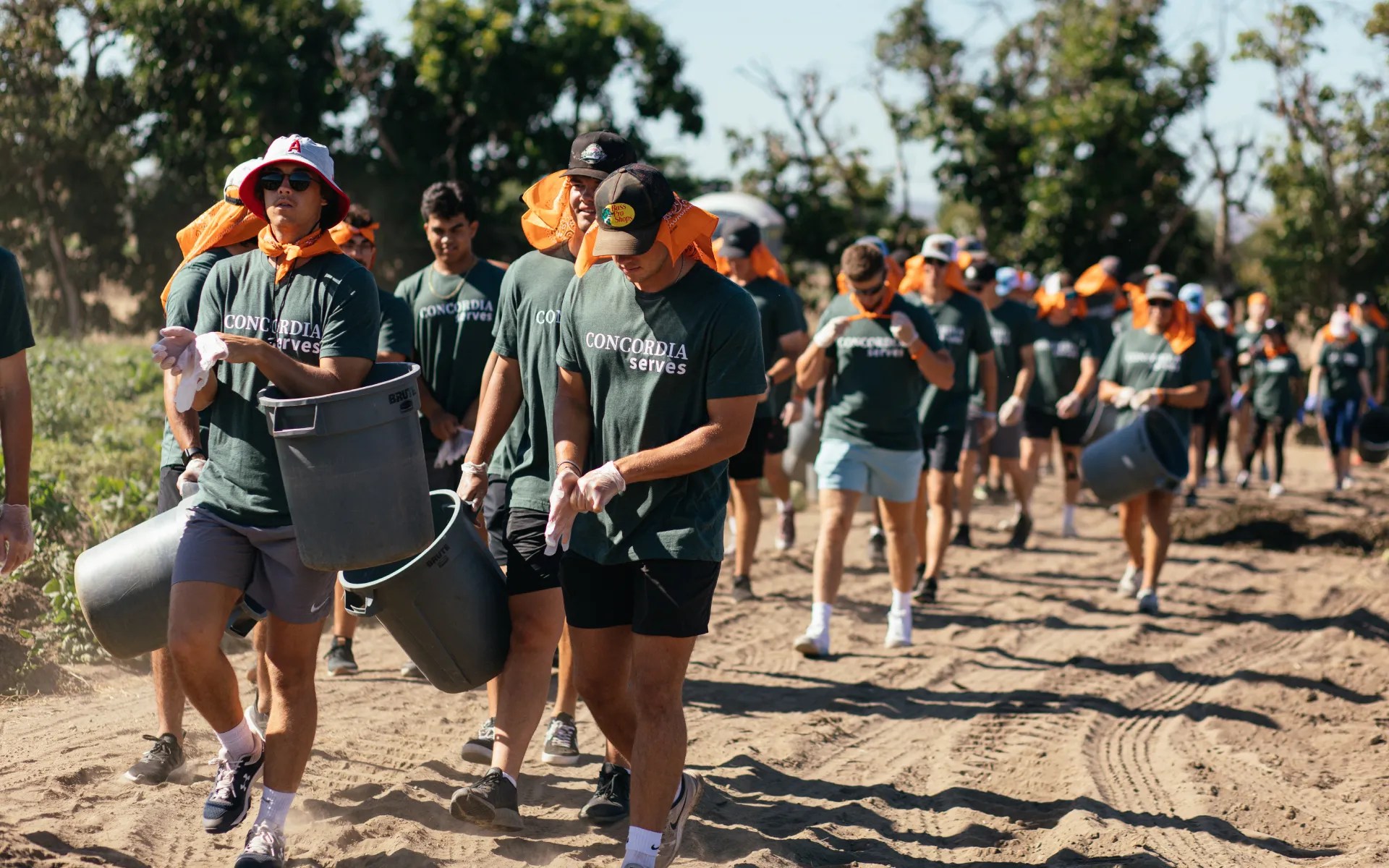 A group of people carrying buckets