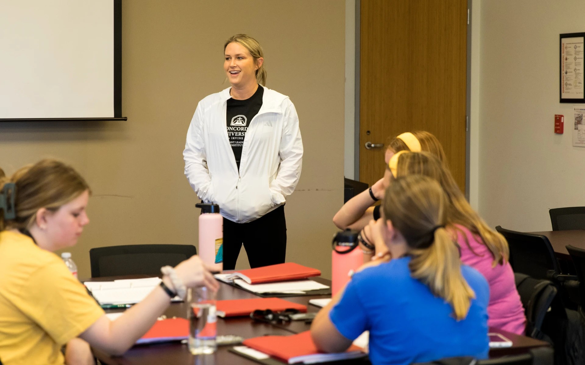A Concordia University Irvine instructor speaks to students during a leadership training session in a classroom