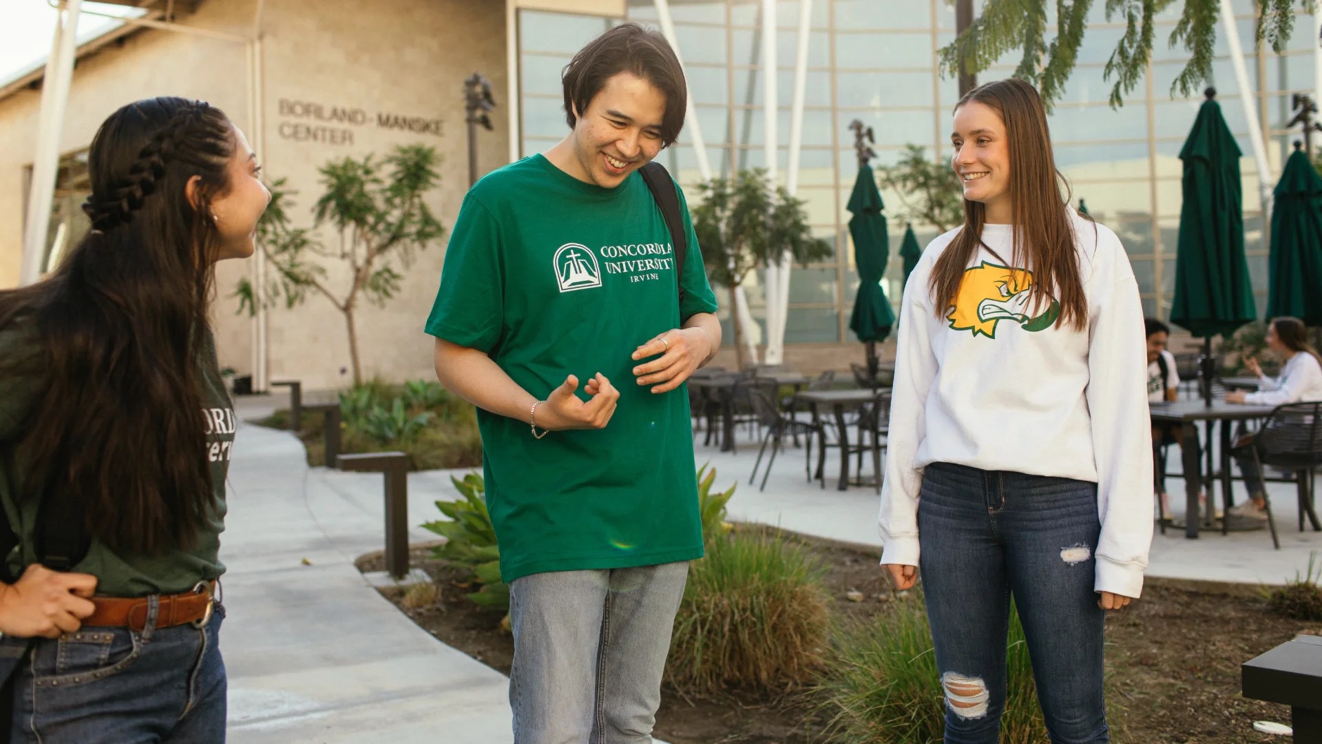 Students talking and laughing outside the Borland-Manske Center at Concordia University Irvine