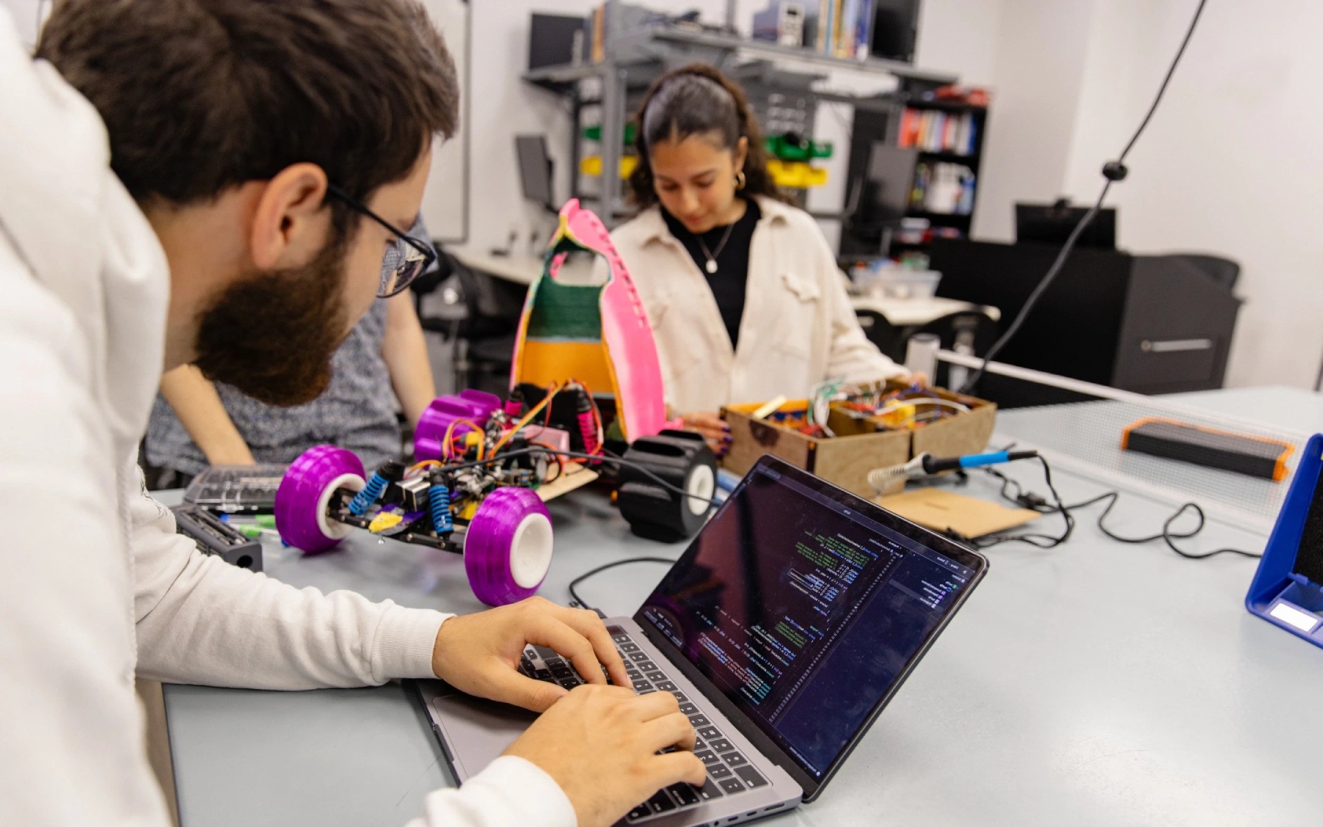 Concordia University Irvine students programming and assembling a robot in a lab