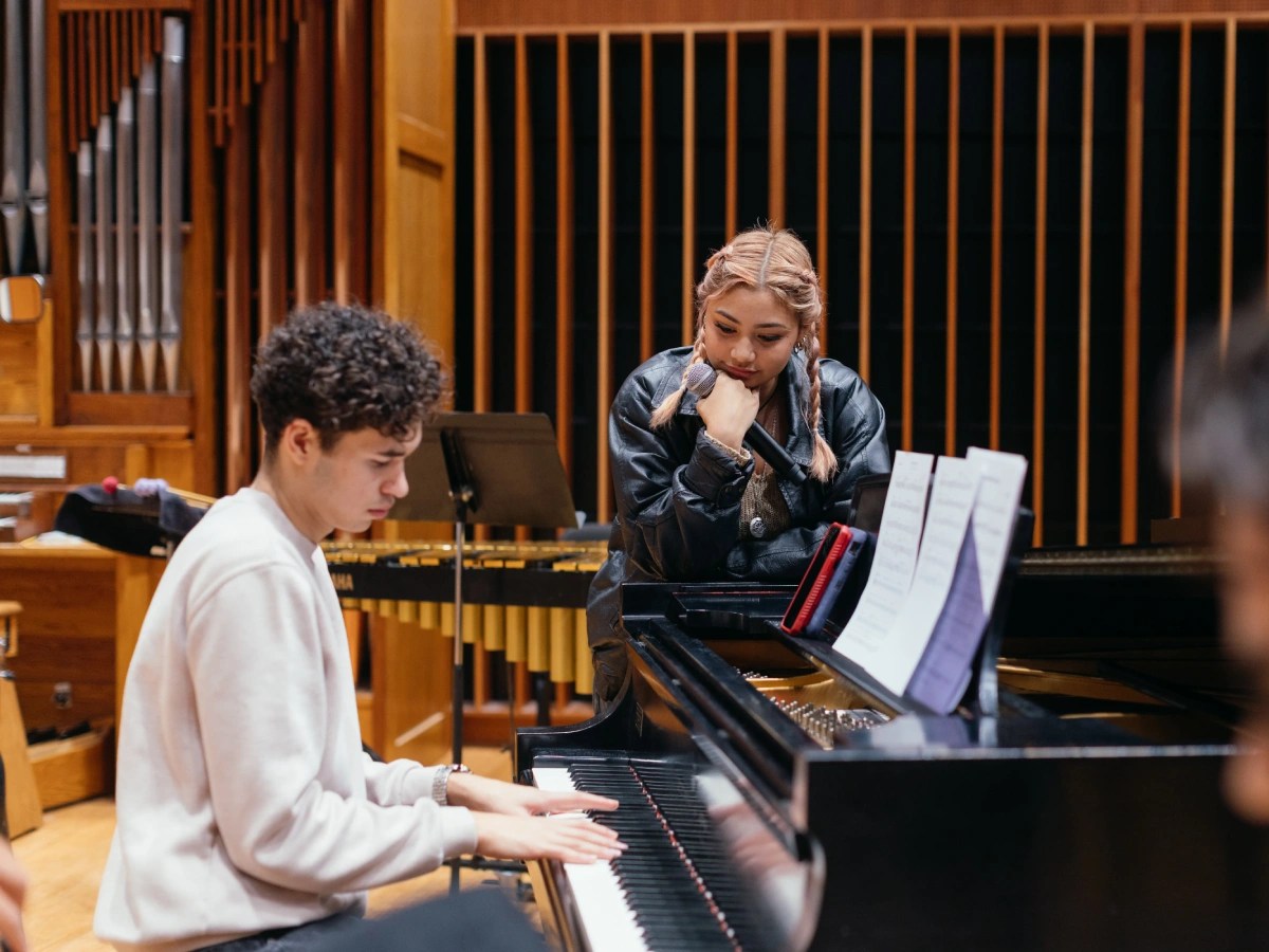 A man and woman playing piano