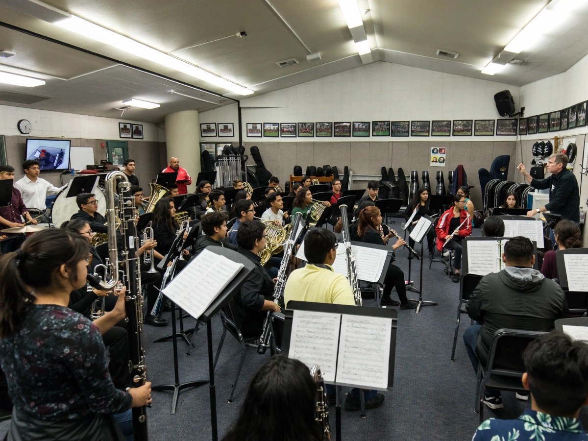 A group of people playing instruments in a room