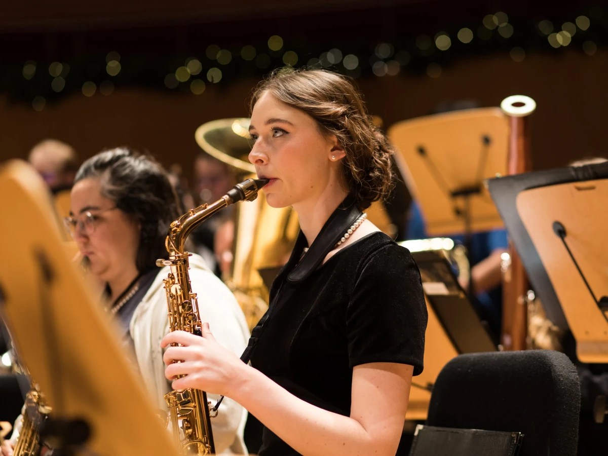 A woman playing a saxophone