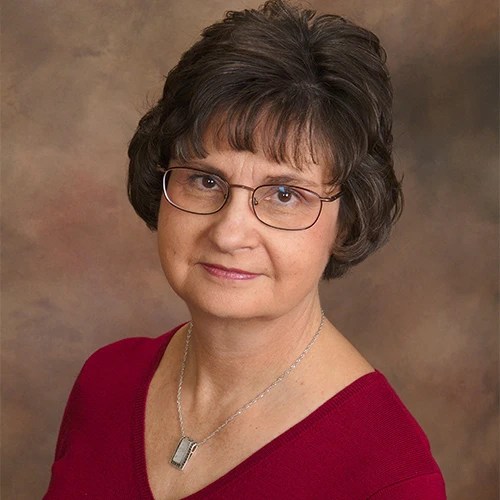 A woman wearing glasses and a red shirt