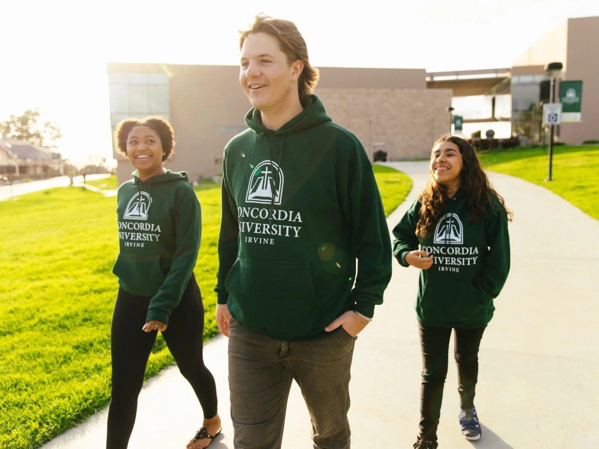 A group of people walking on a sidewalk