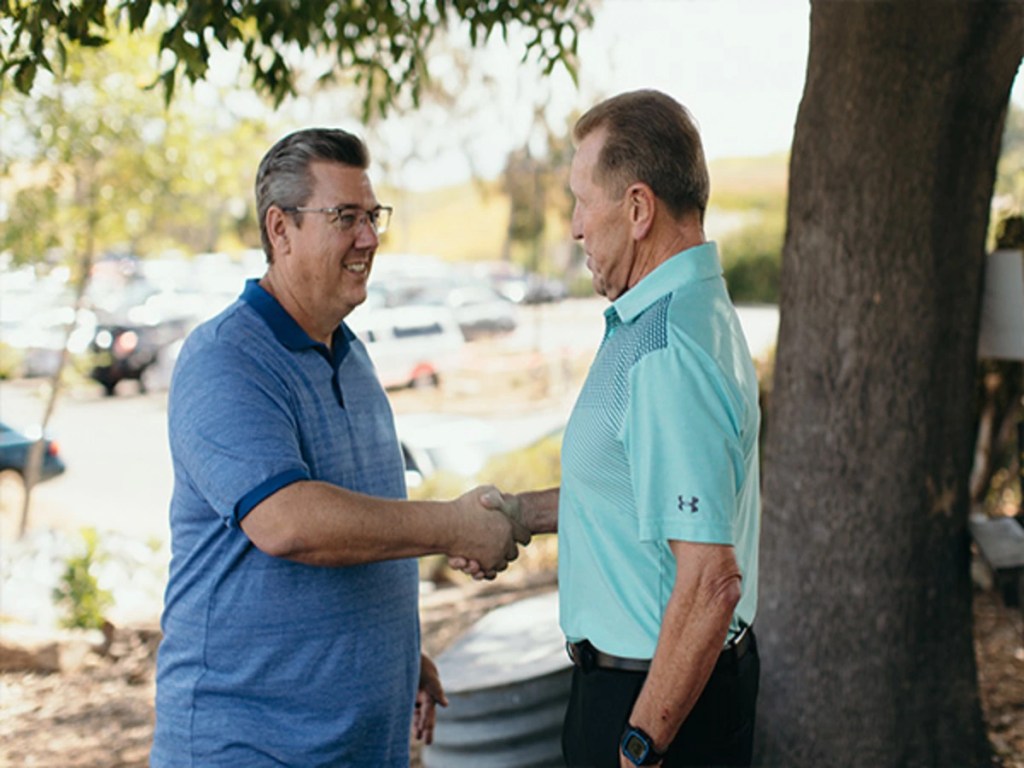 A man shaking hands with Dean Vieselmeyer