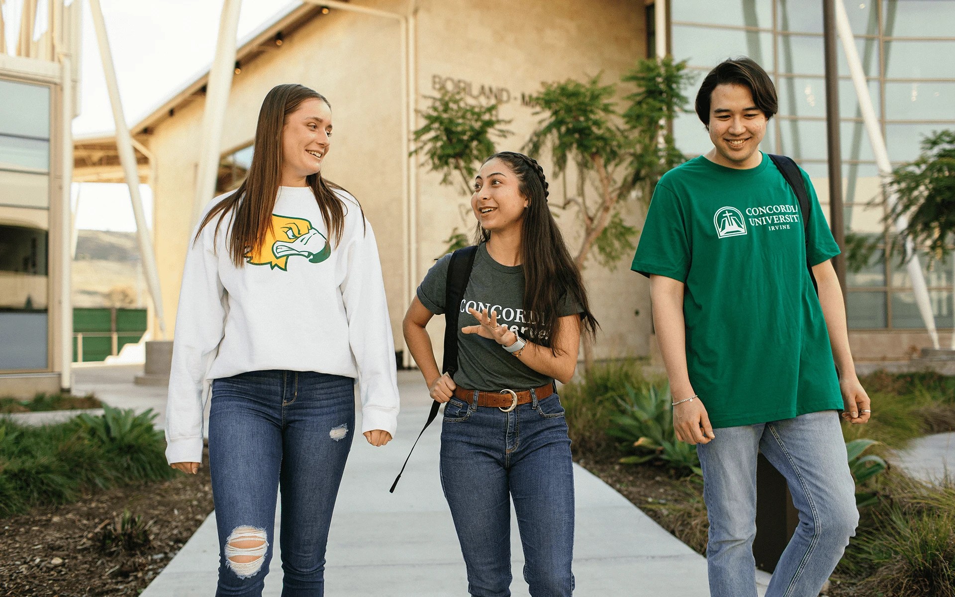 A group of people walking on a sidewalk