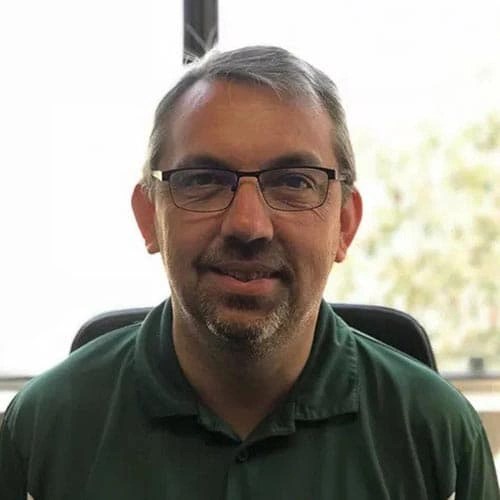 A man wearing glasses and a green shirt