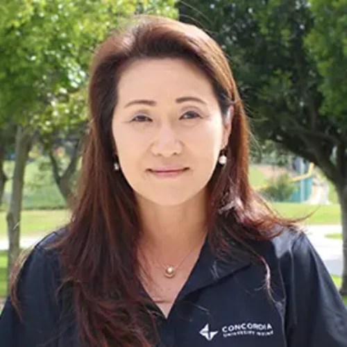 A woman with long hair wearing a black shirt