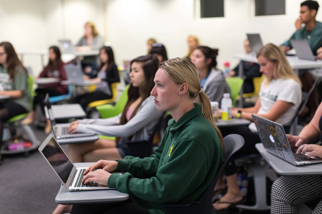 Concordia University Irvine students attending class and taking notes on laptops
