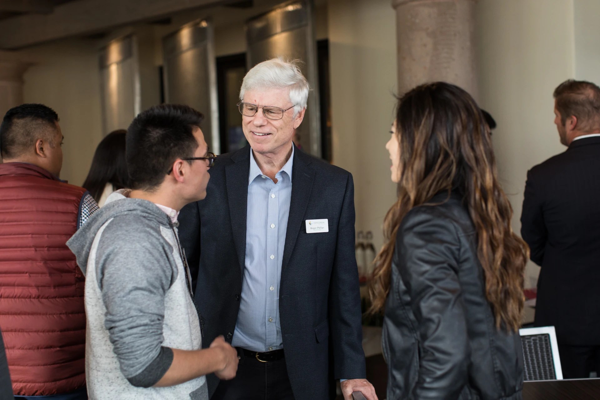Conversation between three people at the MBA Mixer