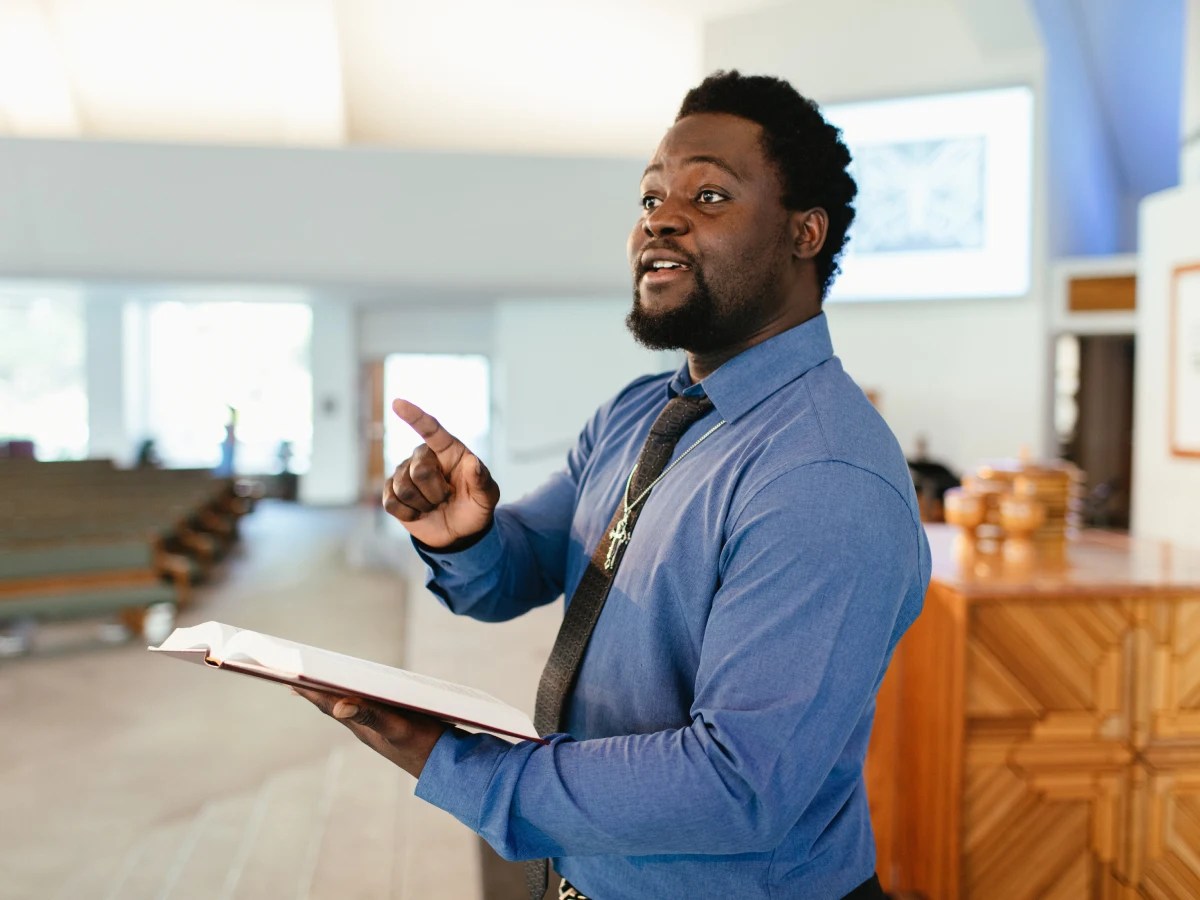 A man holding a book and pointing