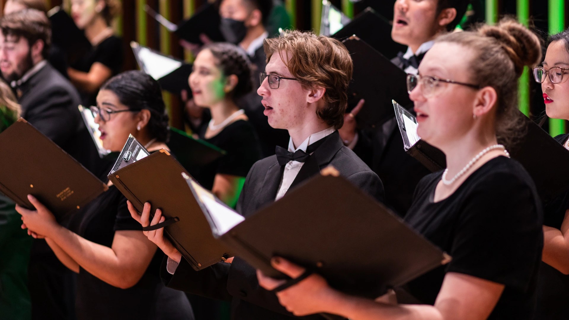 A group of people singing in a choir