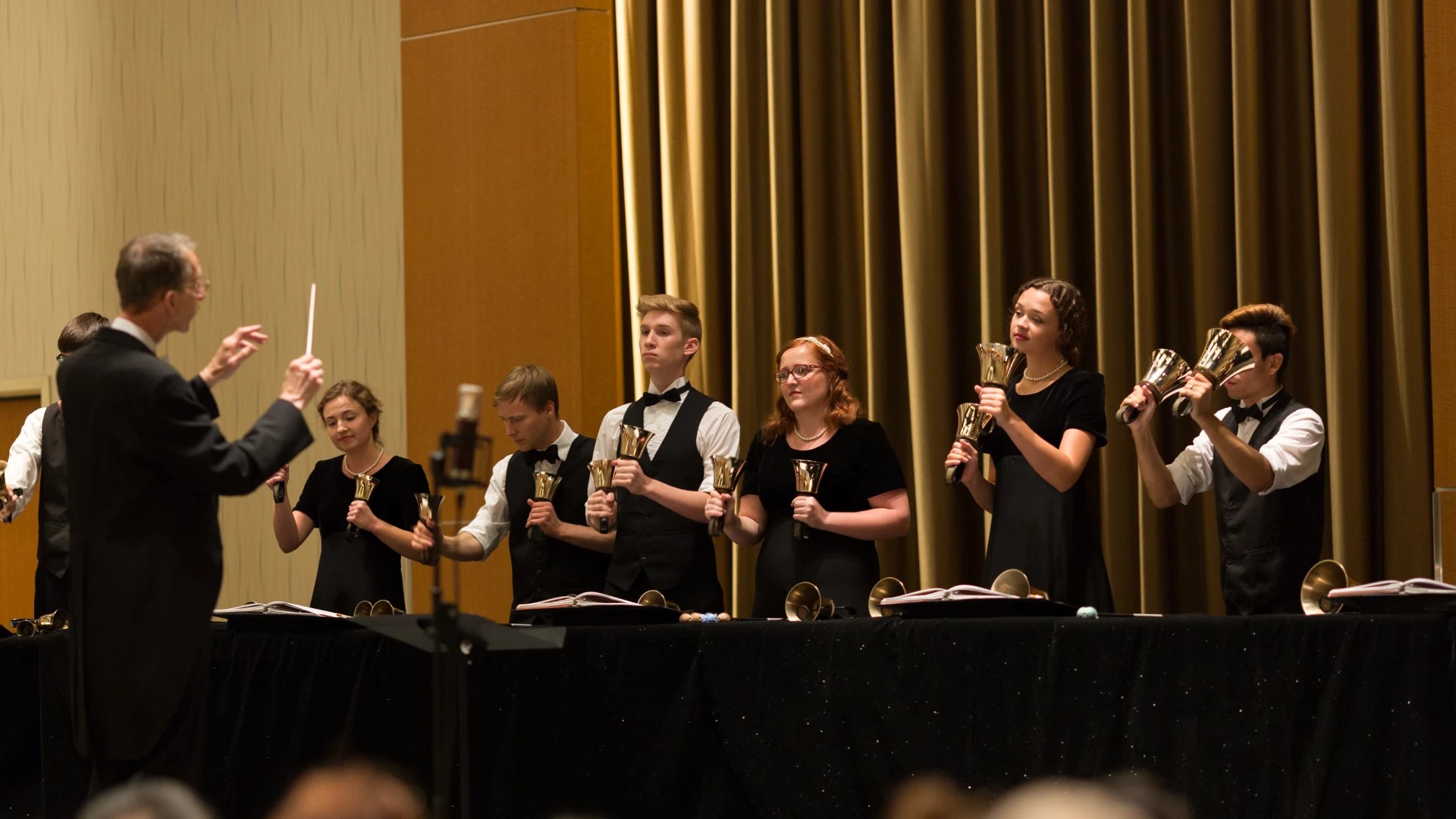 A group of people holding bells