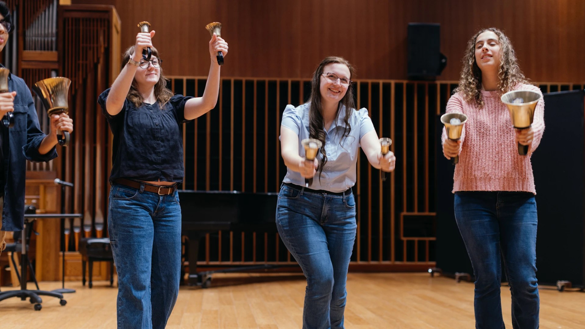 A group of women holding bells