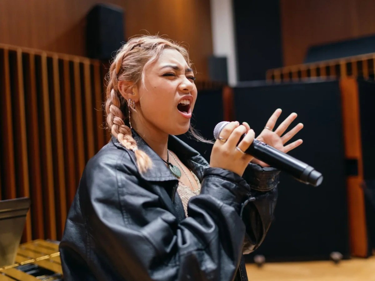 A woman singing into a microphone