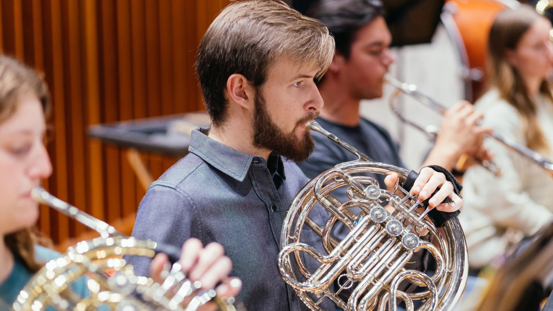 A man playing a french horn