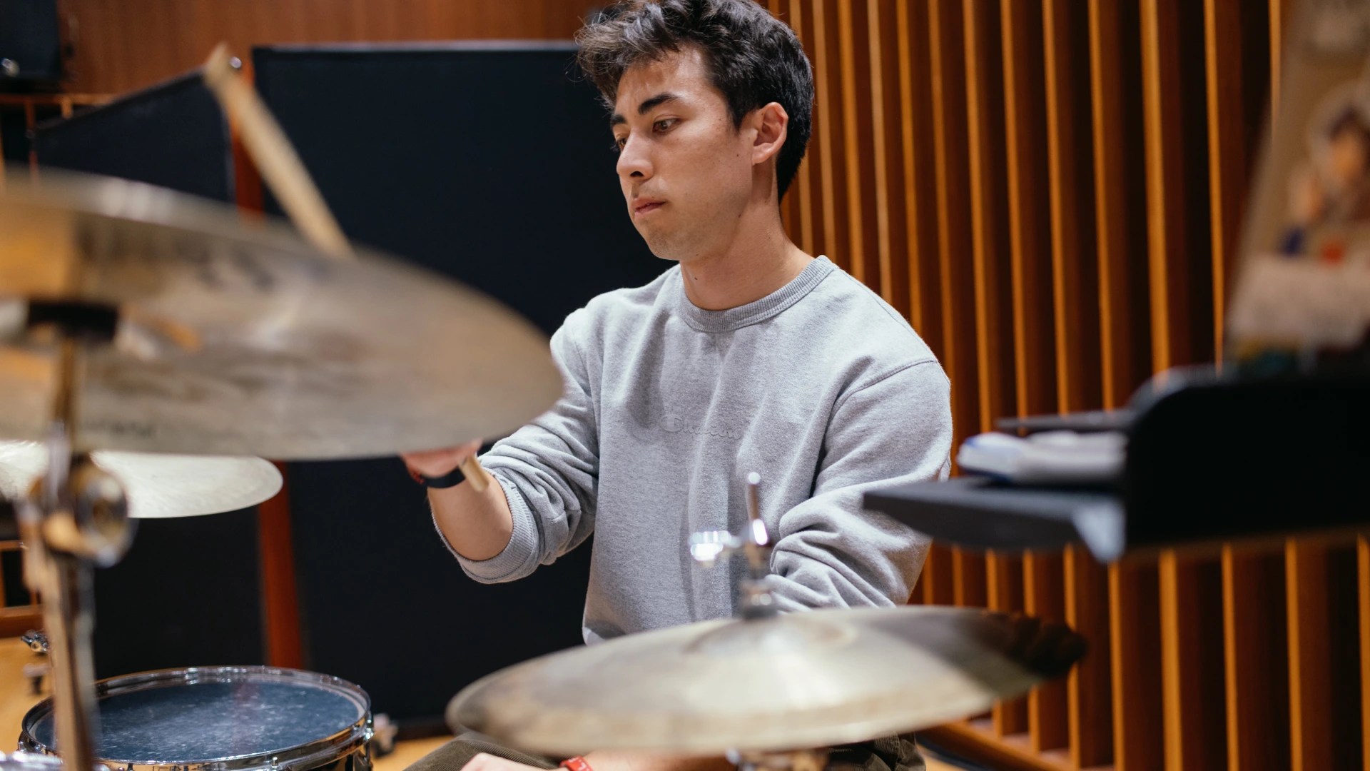 A man playing drums in a recording studio