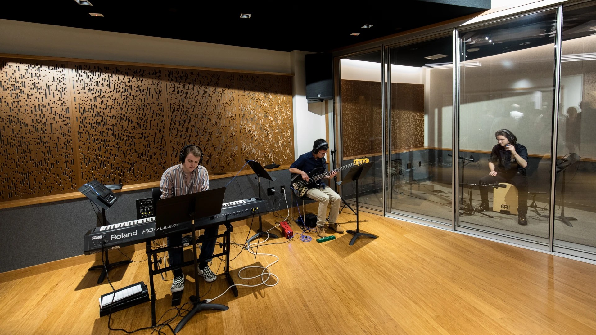A group of people playing instruments in a recording studio