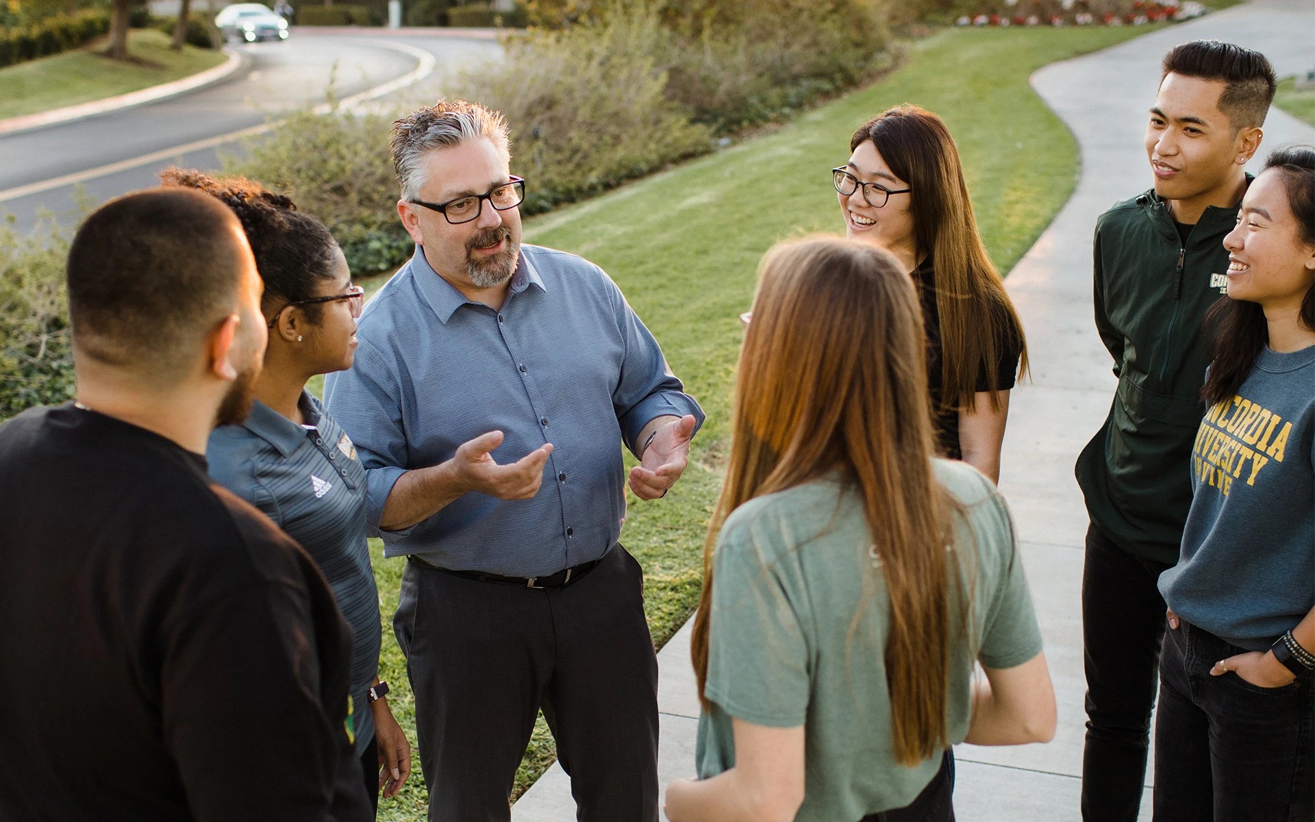 A group of people standing on a sidewalk