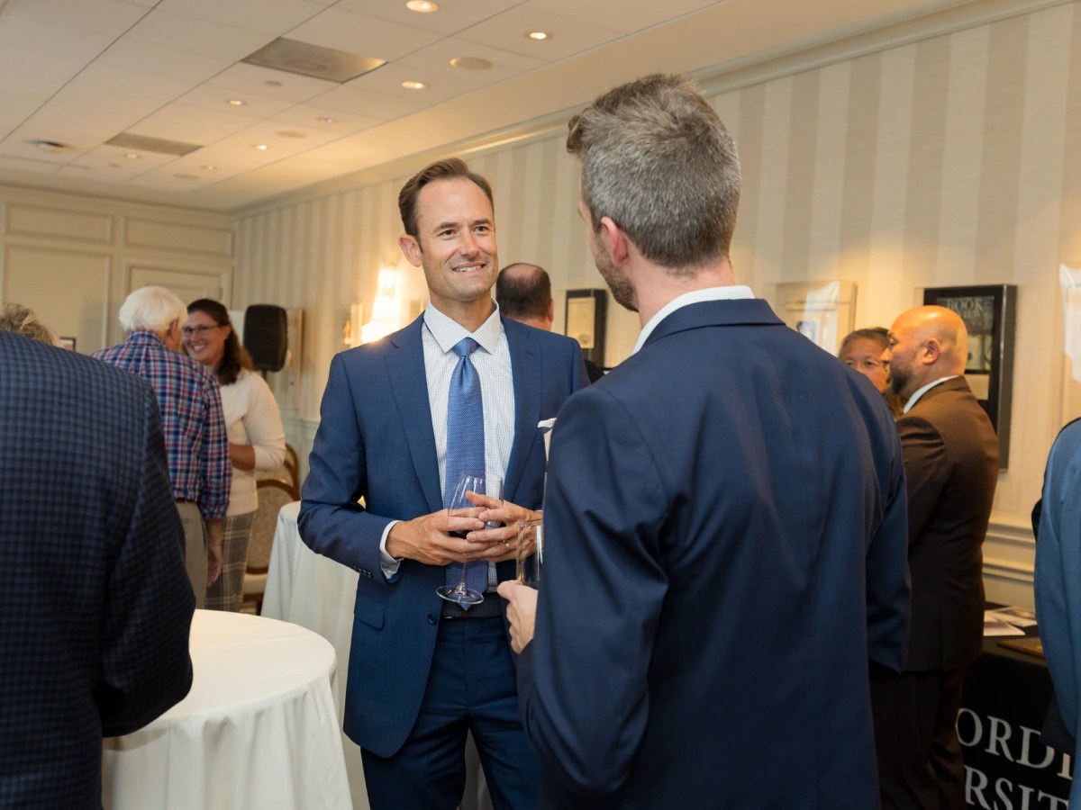 A group of men in suits talking to each other