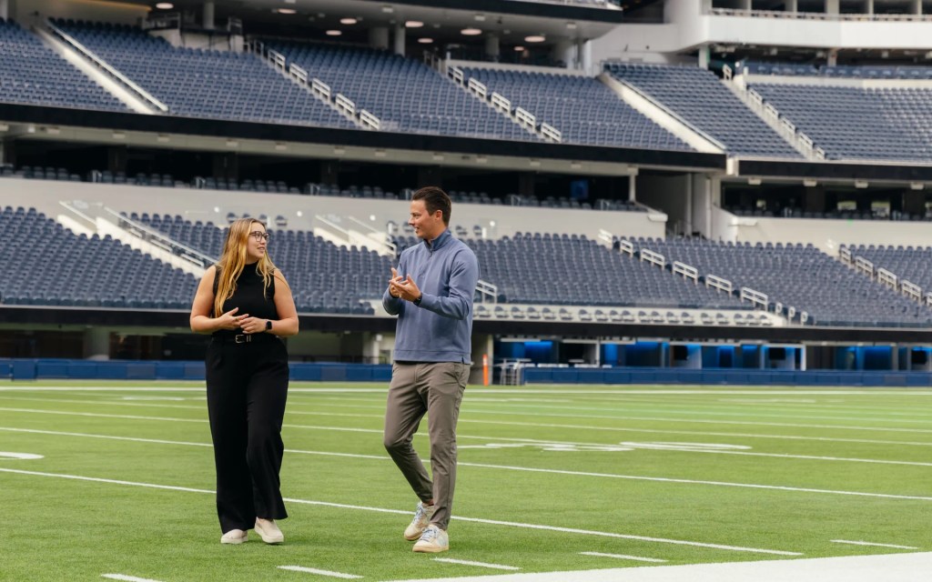 A man and woman on a football field