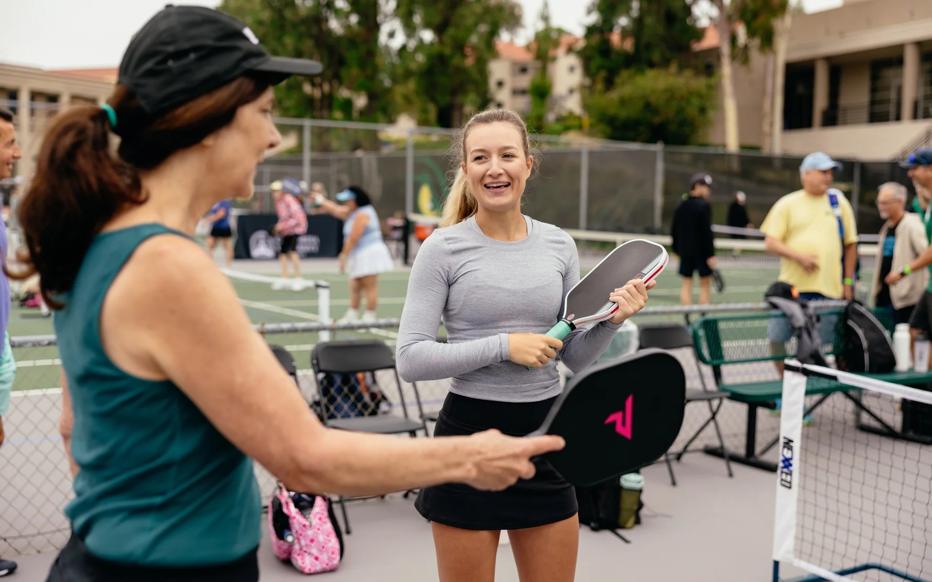 A woman holding a paddle and a racket