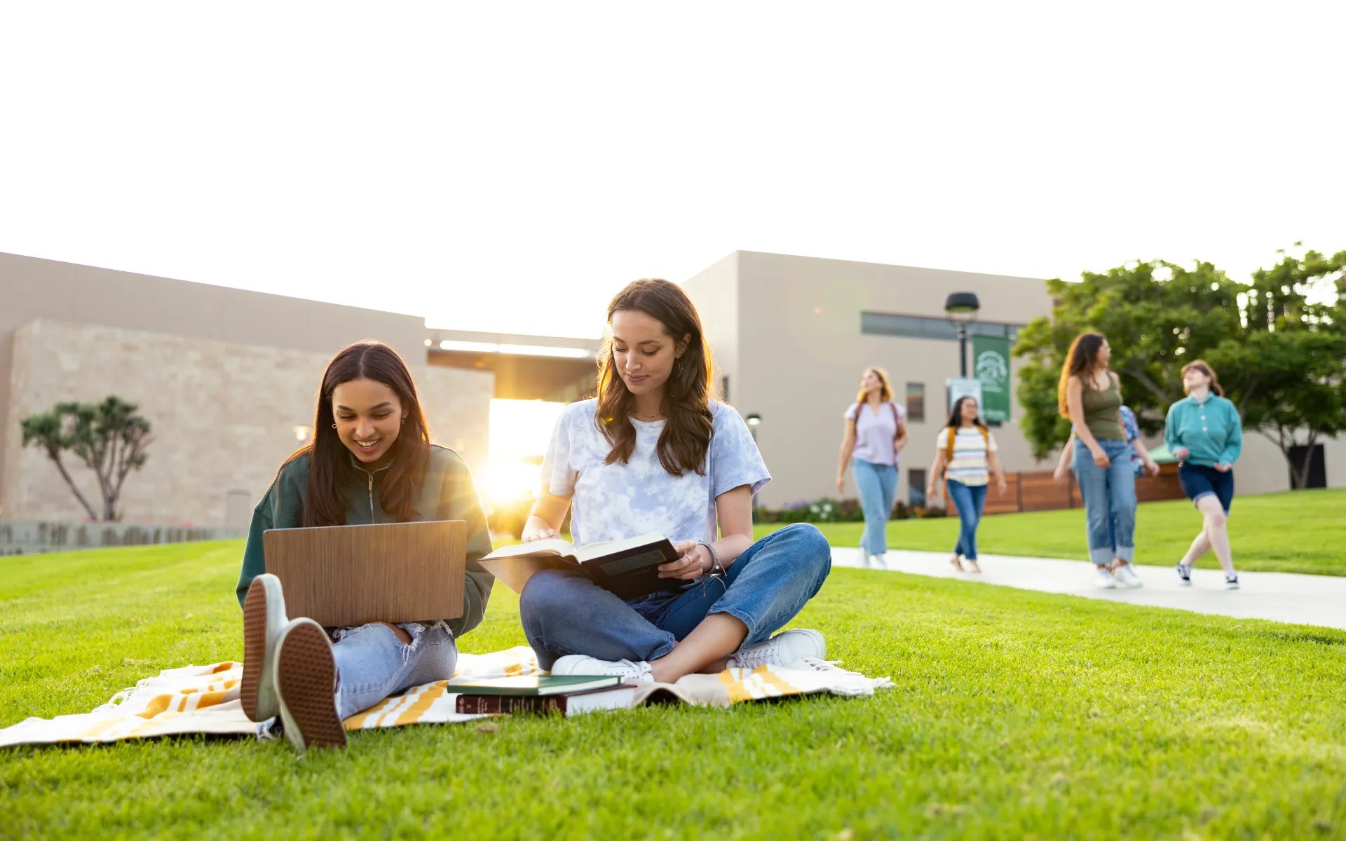 A group of young women sitting on the grass