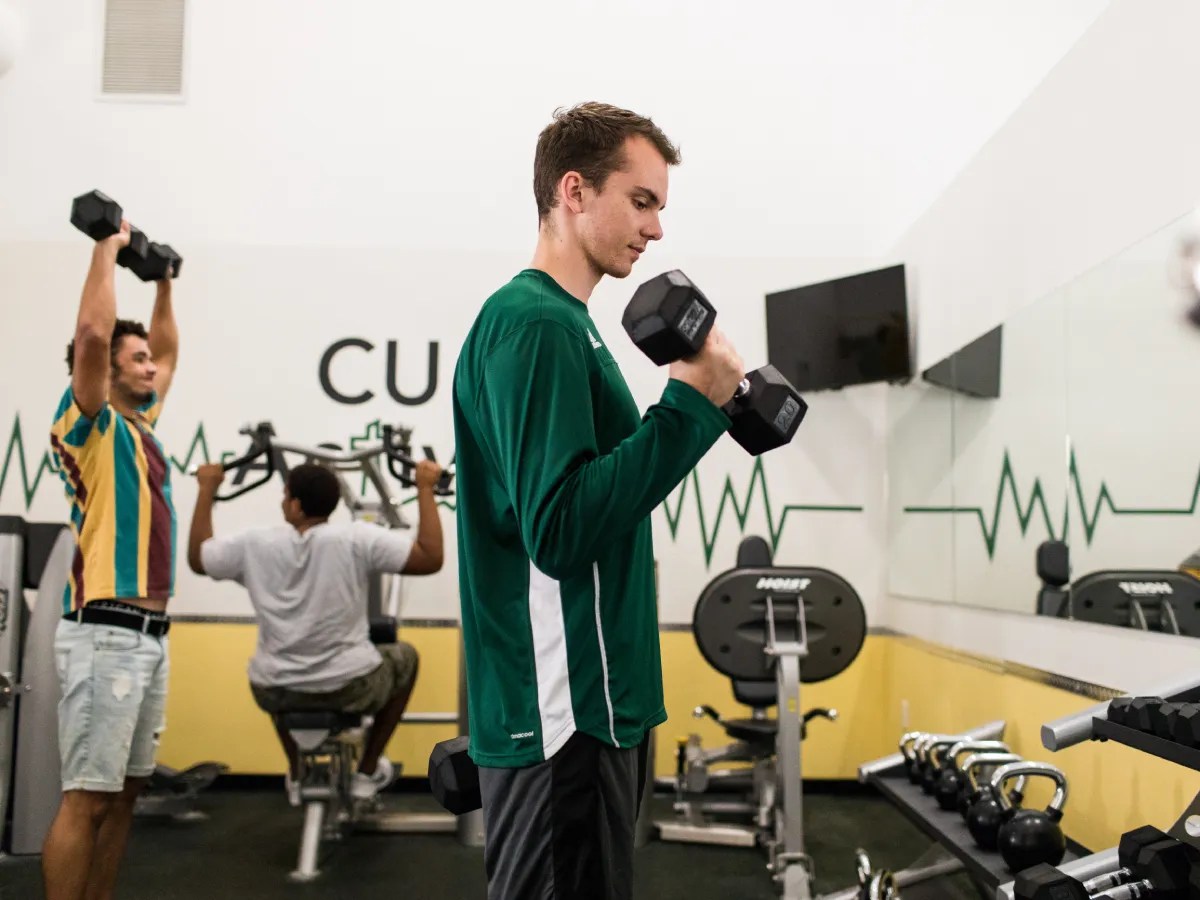 A man lifting weights in a gym