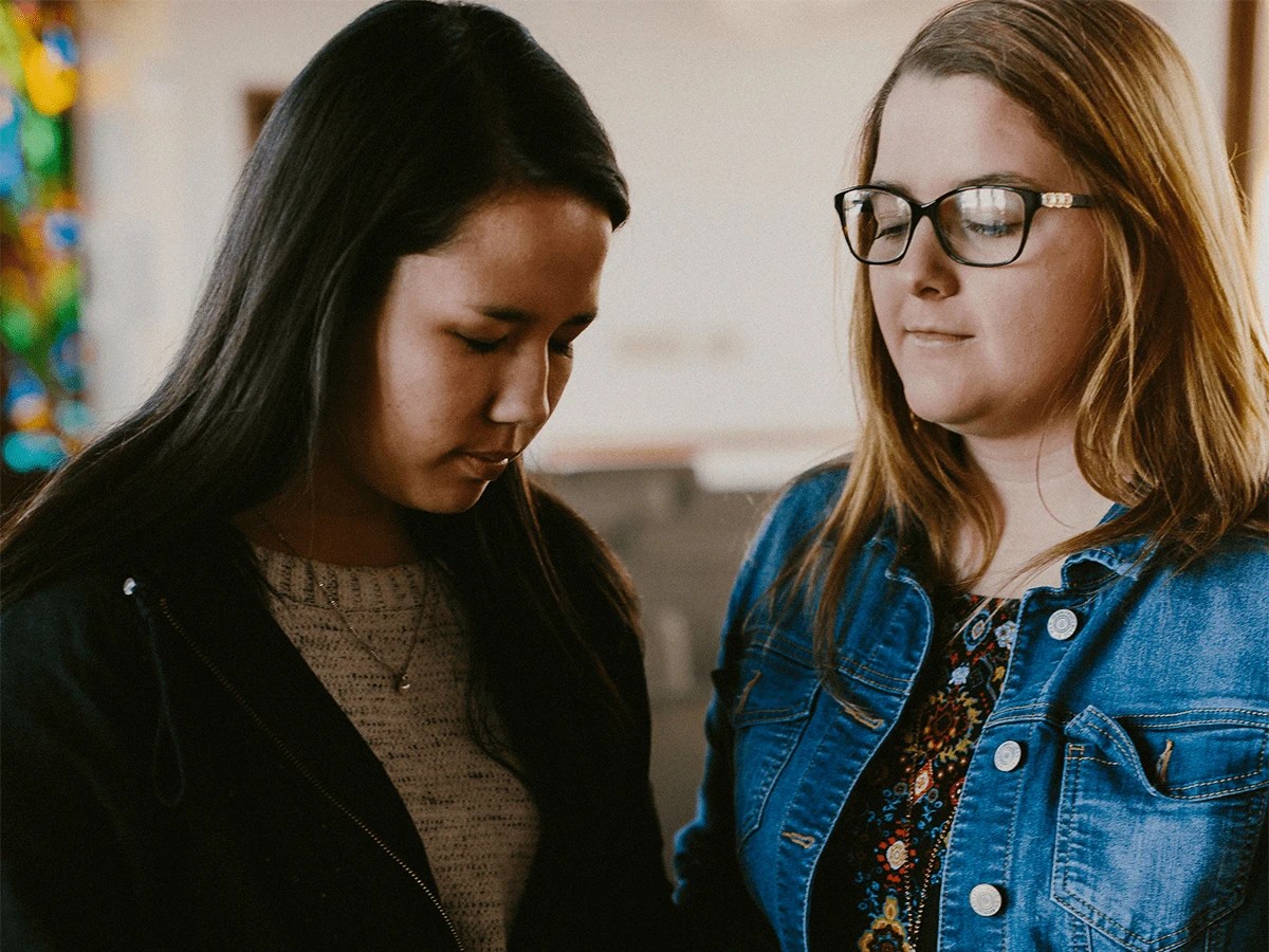 A couple of women looking down