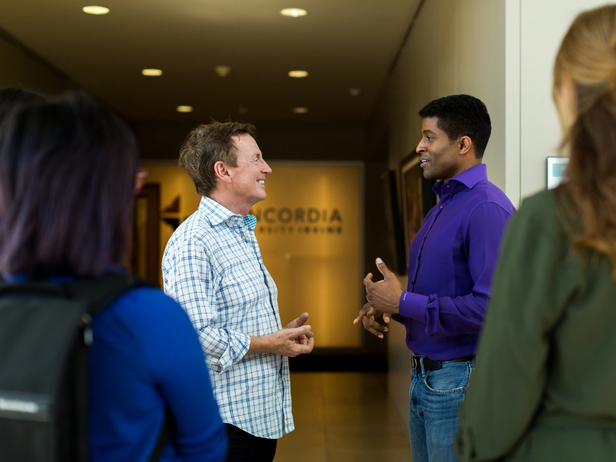 A group of men talking in a hallway