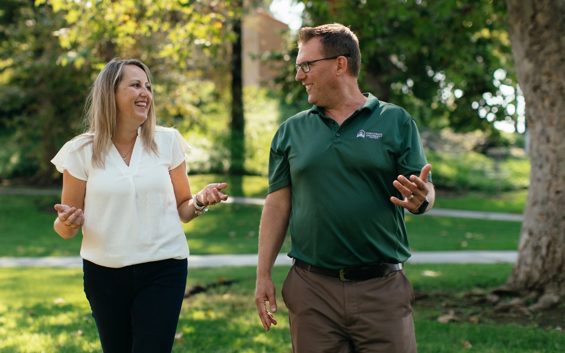 A man and woman talking in a park