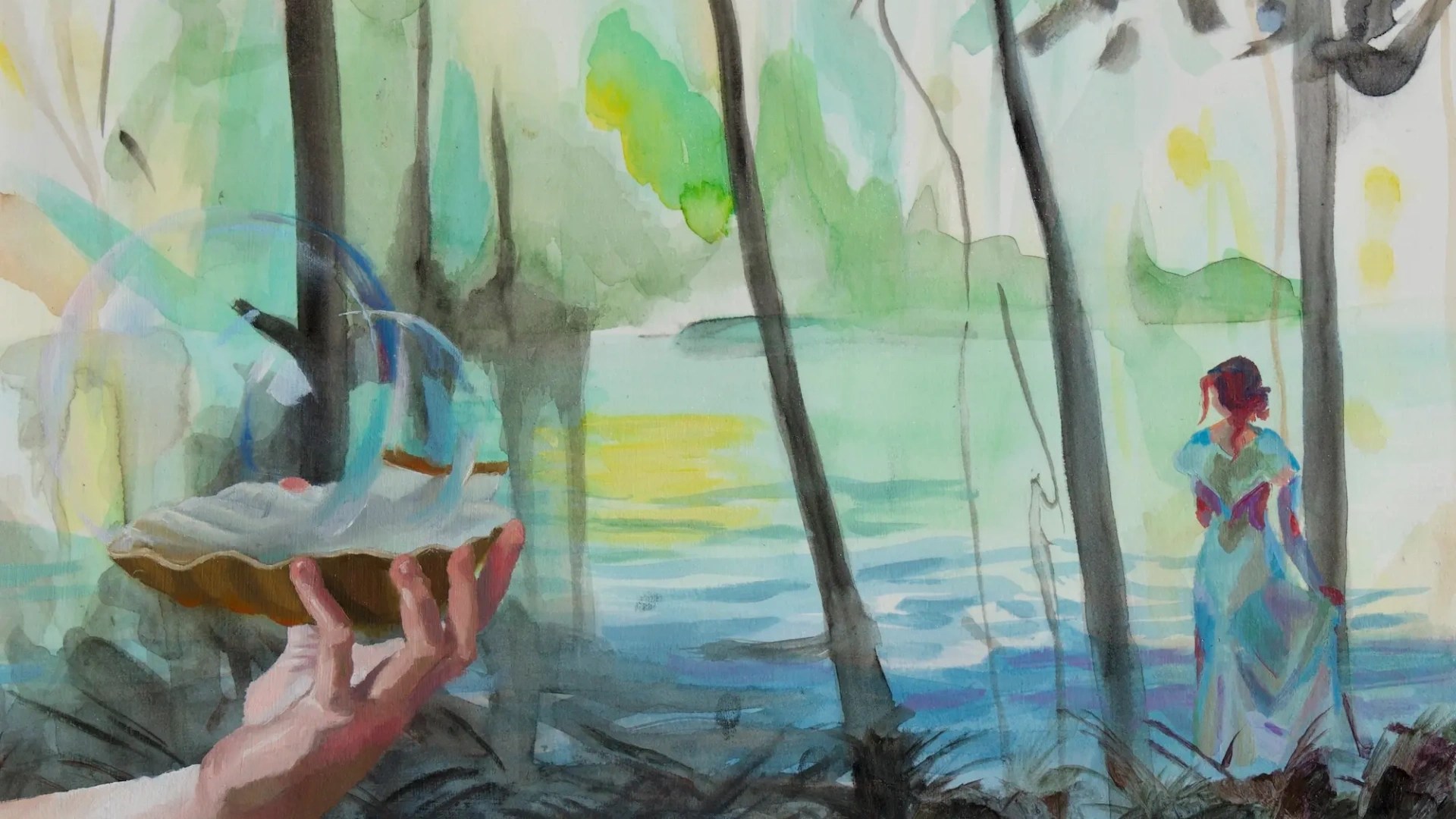 A hand holding a glass bowl in front of a water body