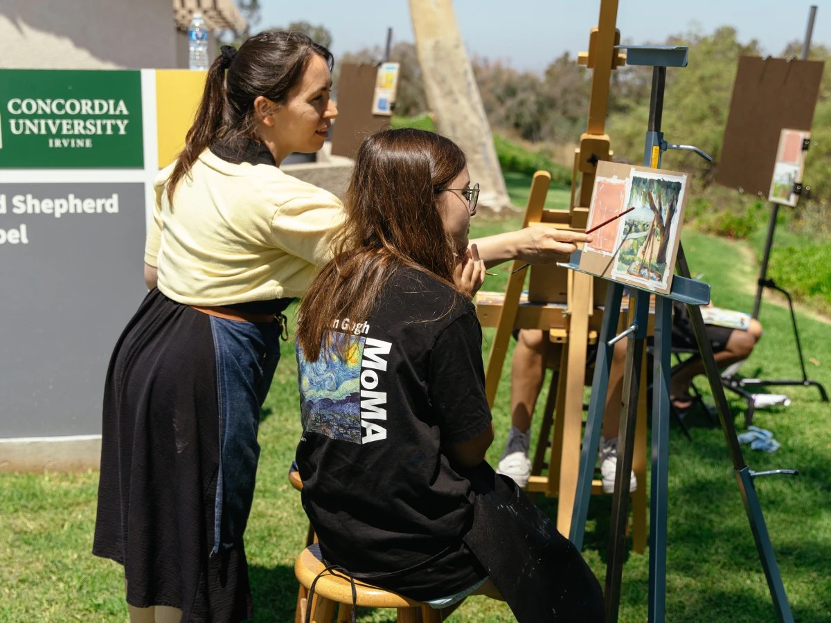 A woman painting on an easel