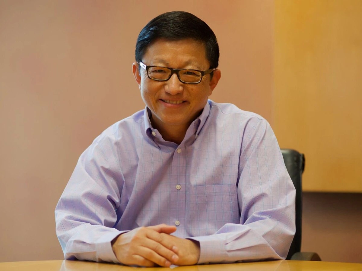 A man wearing glasses and a purple shirt