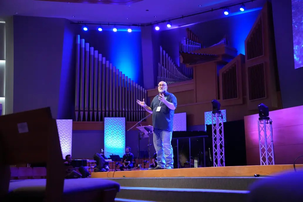 A man on a stage with a microphone