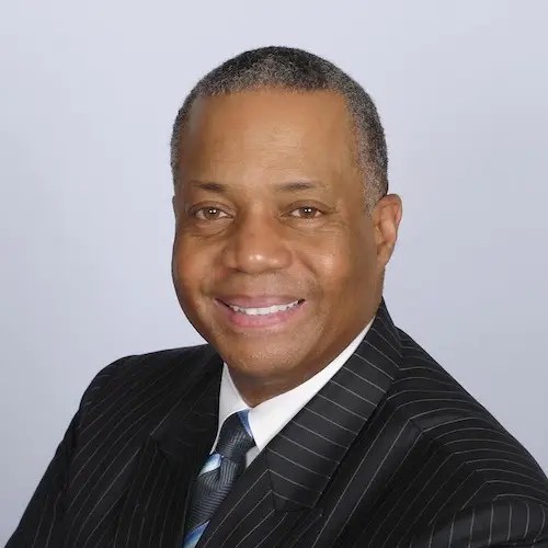 A man in a suit smiling