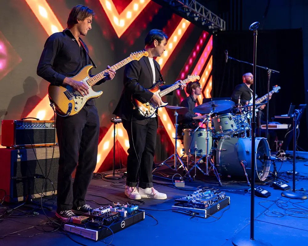 A group of men playing instruments on a stage