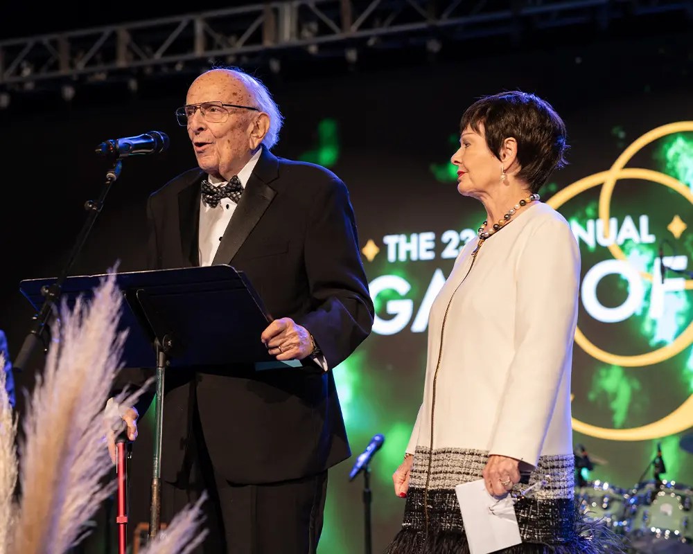 A man and woman standing on a stage