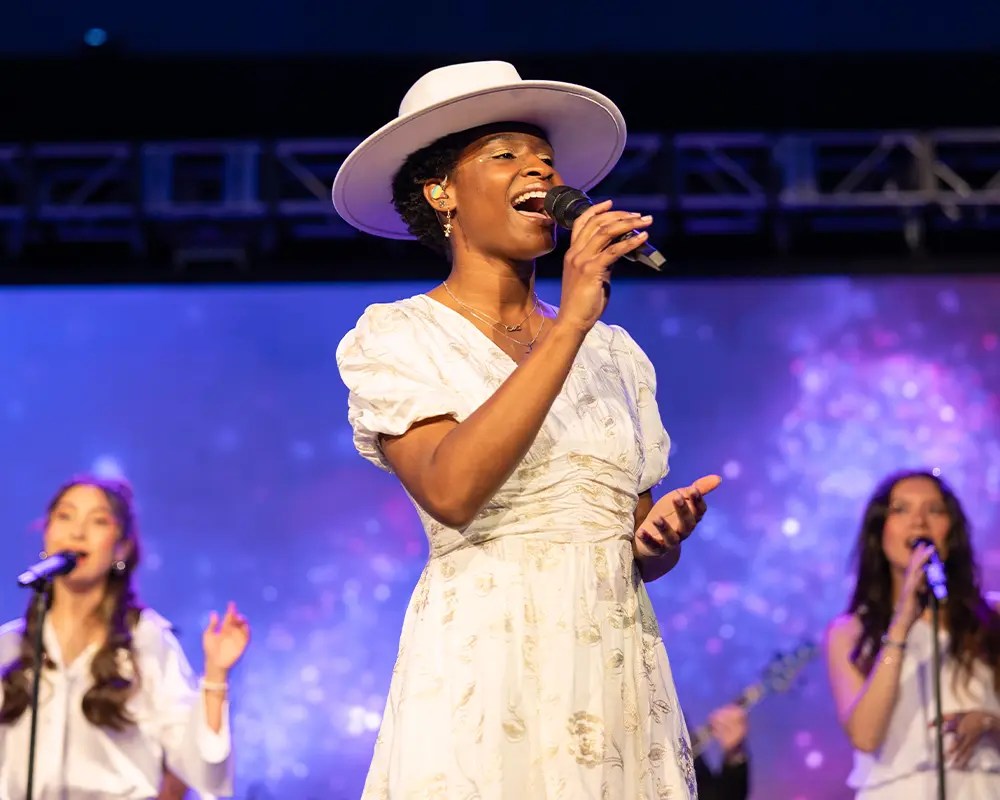 A woman singing into a microphone