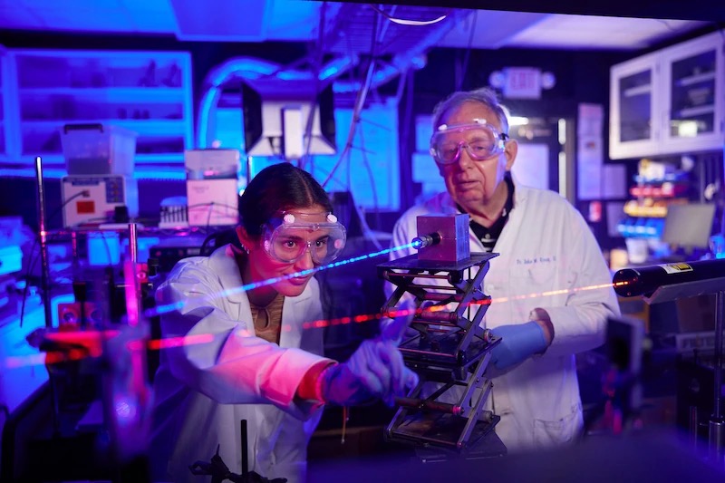A couple of people in lab coats and goggles