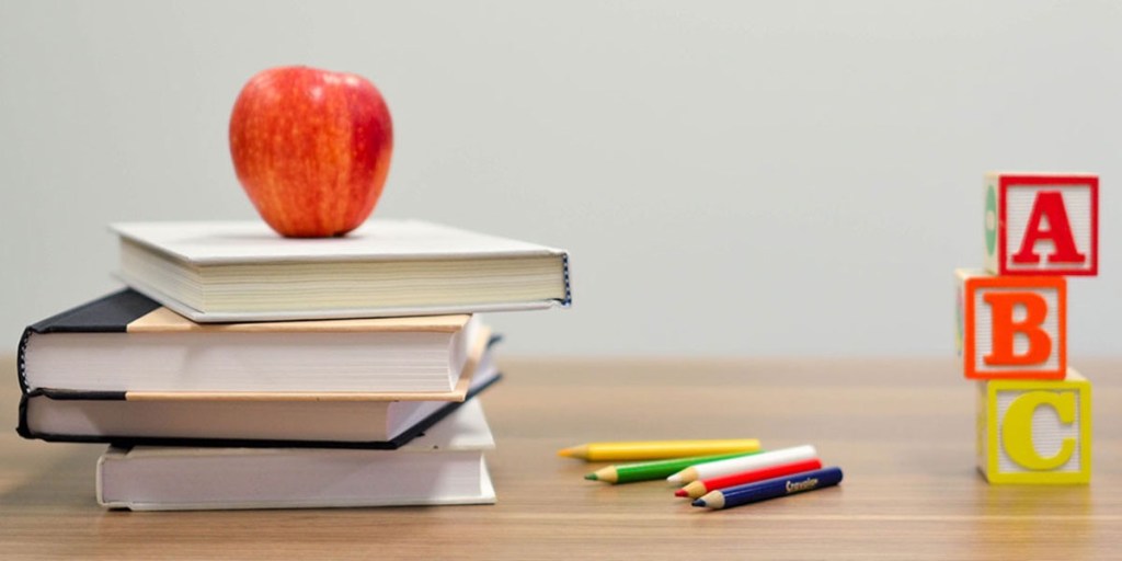 A apple on top of a stack of books