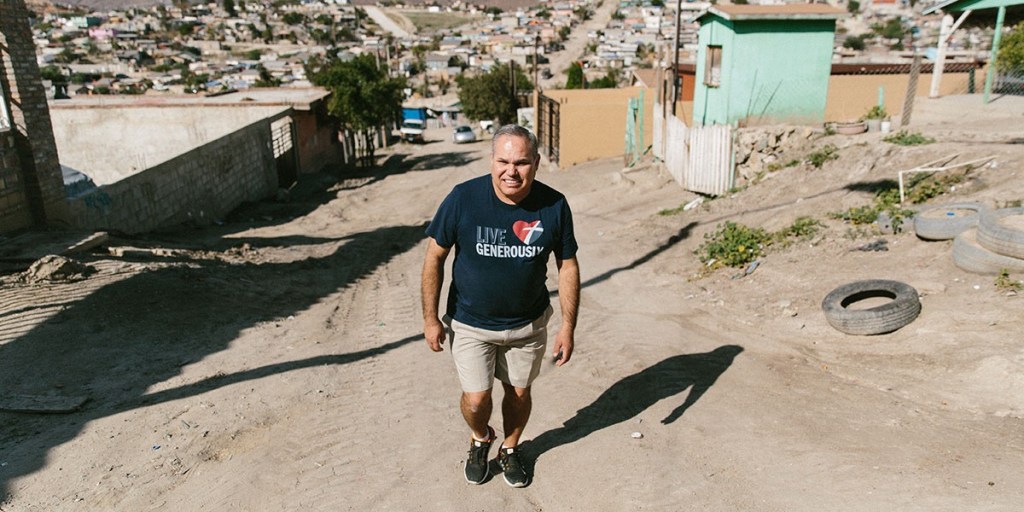 A man walking down a dirt road